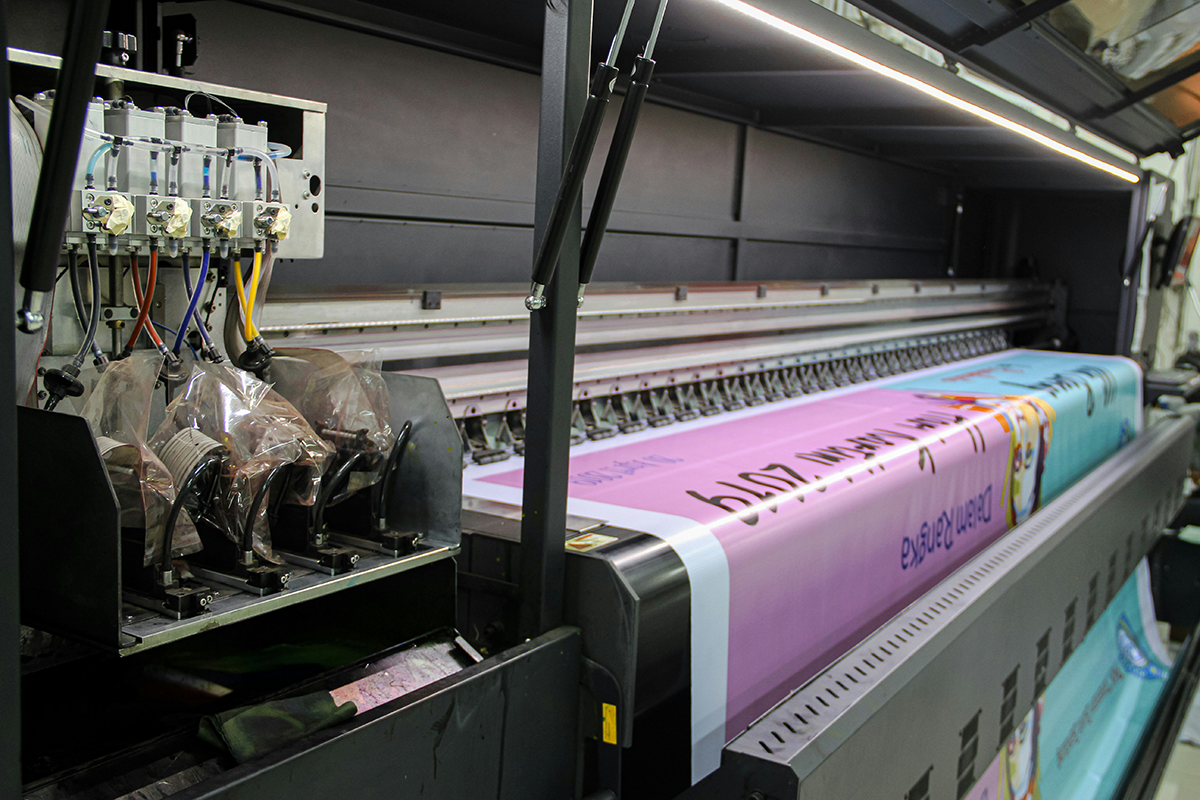 Professional graphic design and print services - industrial printer creating high-quality materials